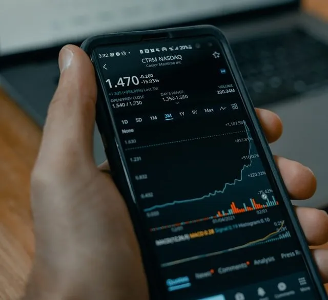 A trader checking live share prices on a mobile terminal